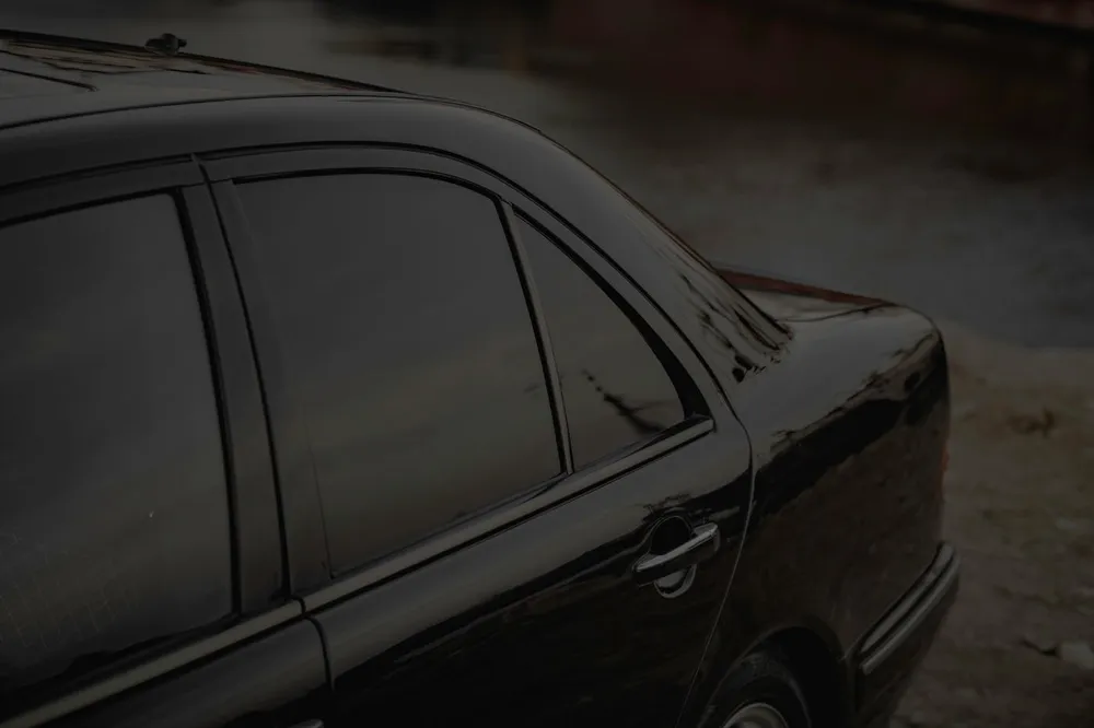 Close-up of ceramic tint film on a dark car rear window