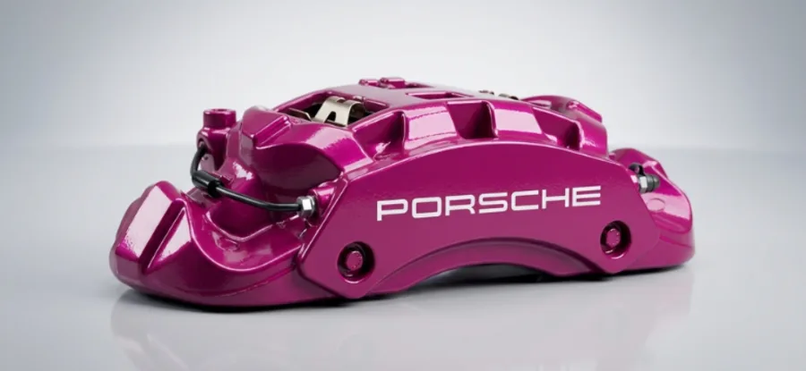 Porsche brake caliper painted magenta with custom white lettering